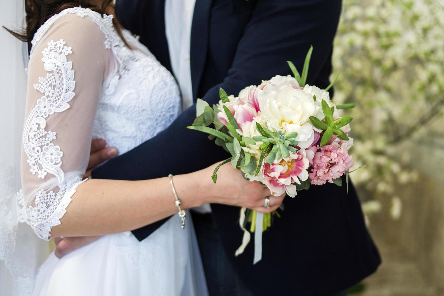 Bride and groom hugging photo