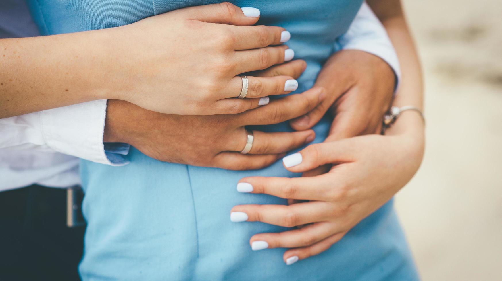 Couple in blue embracing photo