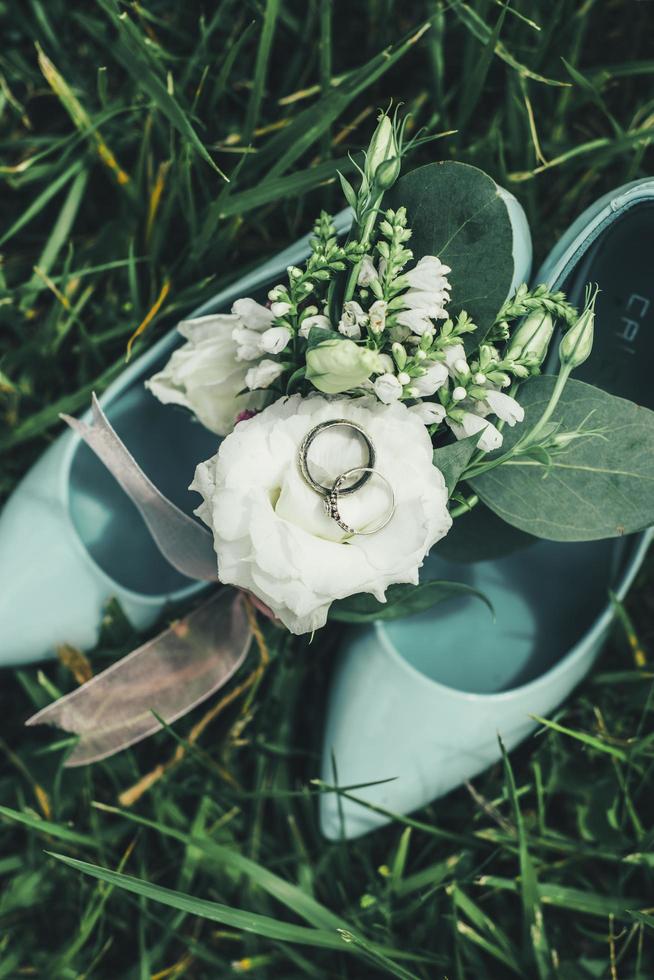 Wedding shoes with flowers and rings photo