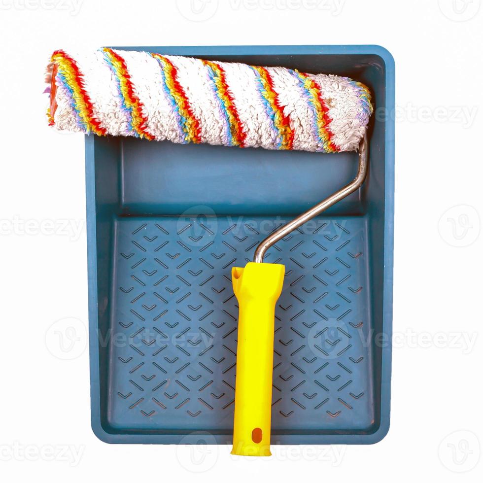 Paint tray and construction roller isolated on a white background photo