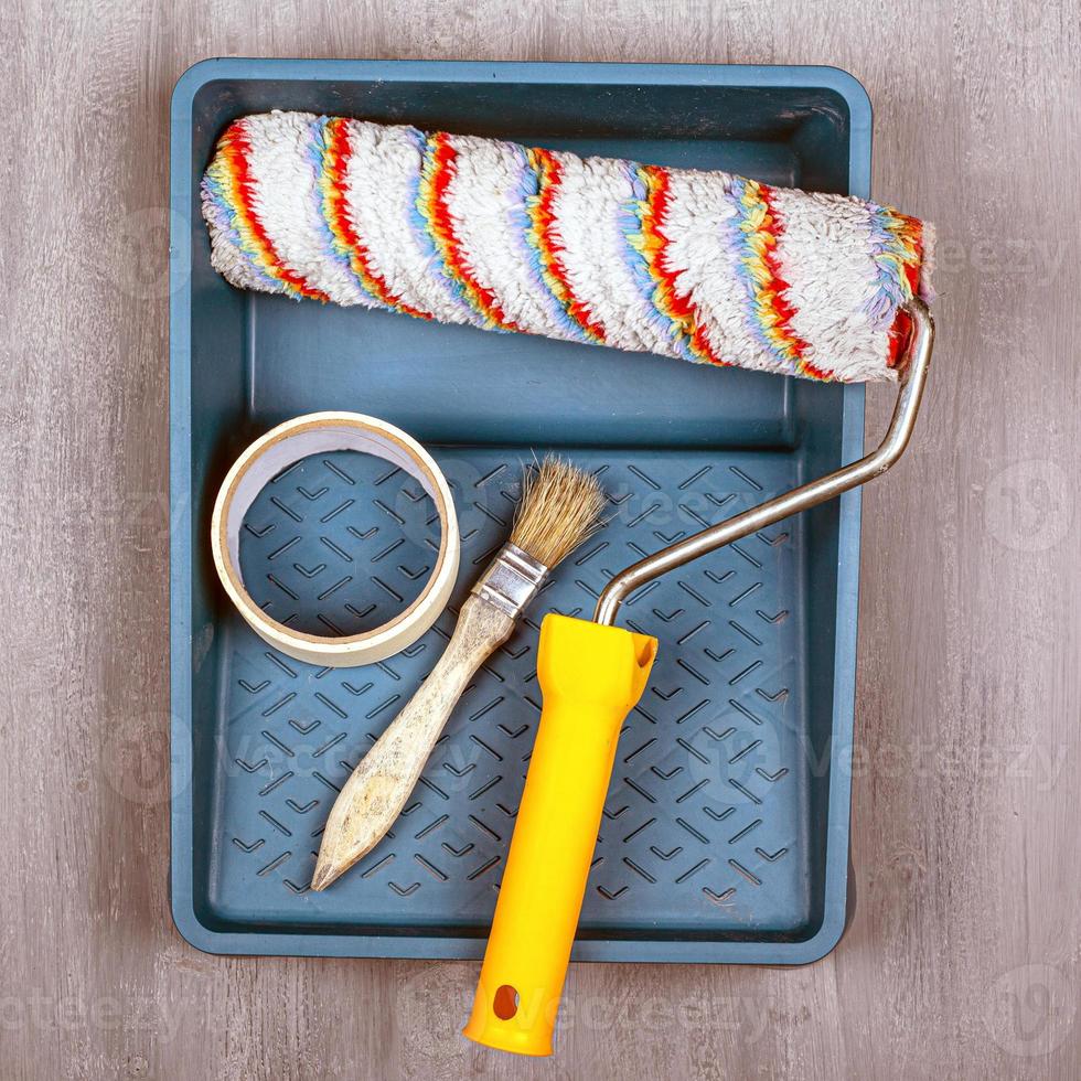 Set of tools for painting with a roller, tray and brush photo