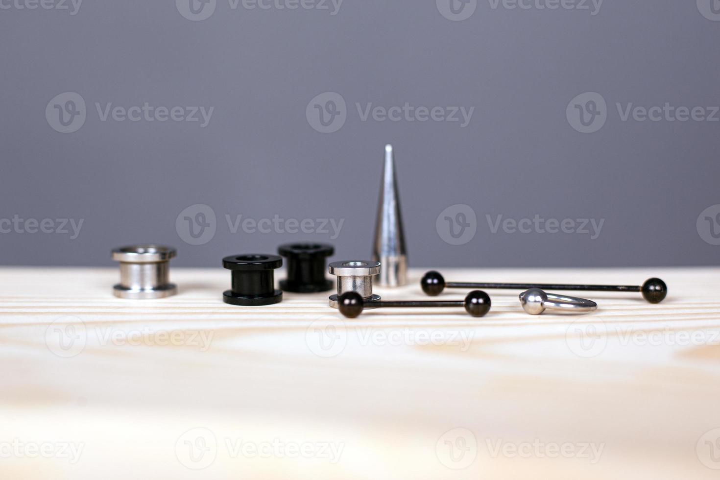 Ear piercing set of accessories on gray background photo