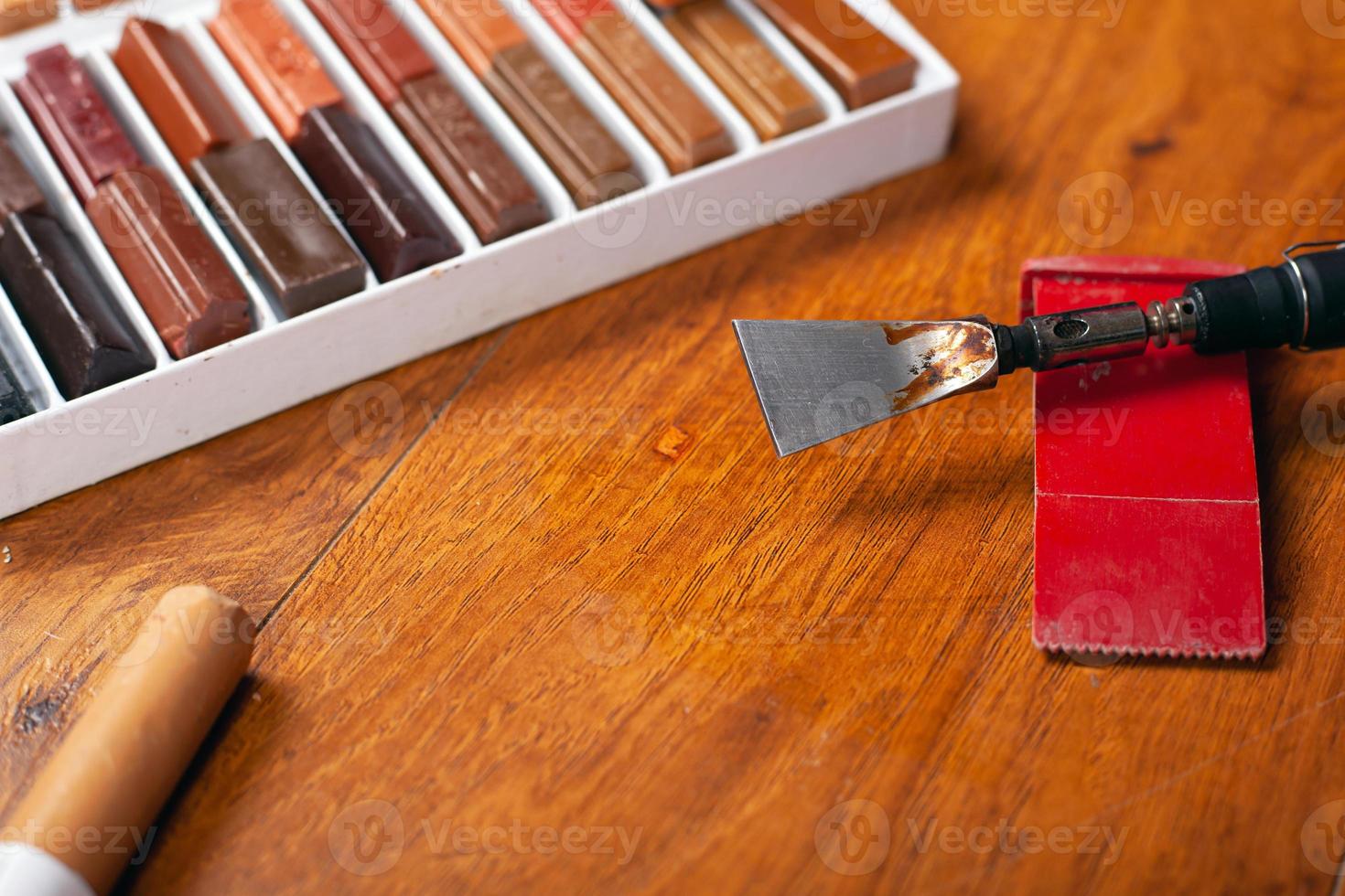 Tools and a set of wax pencils for sealing scratches and chips photo