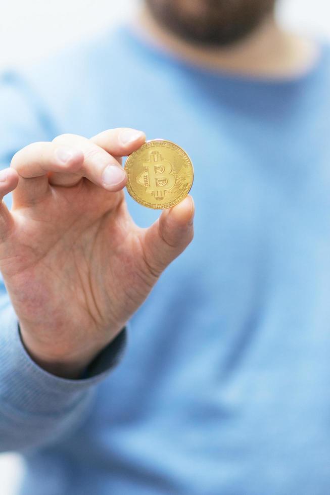 Man holding bitcoin in the hand photo