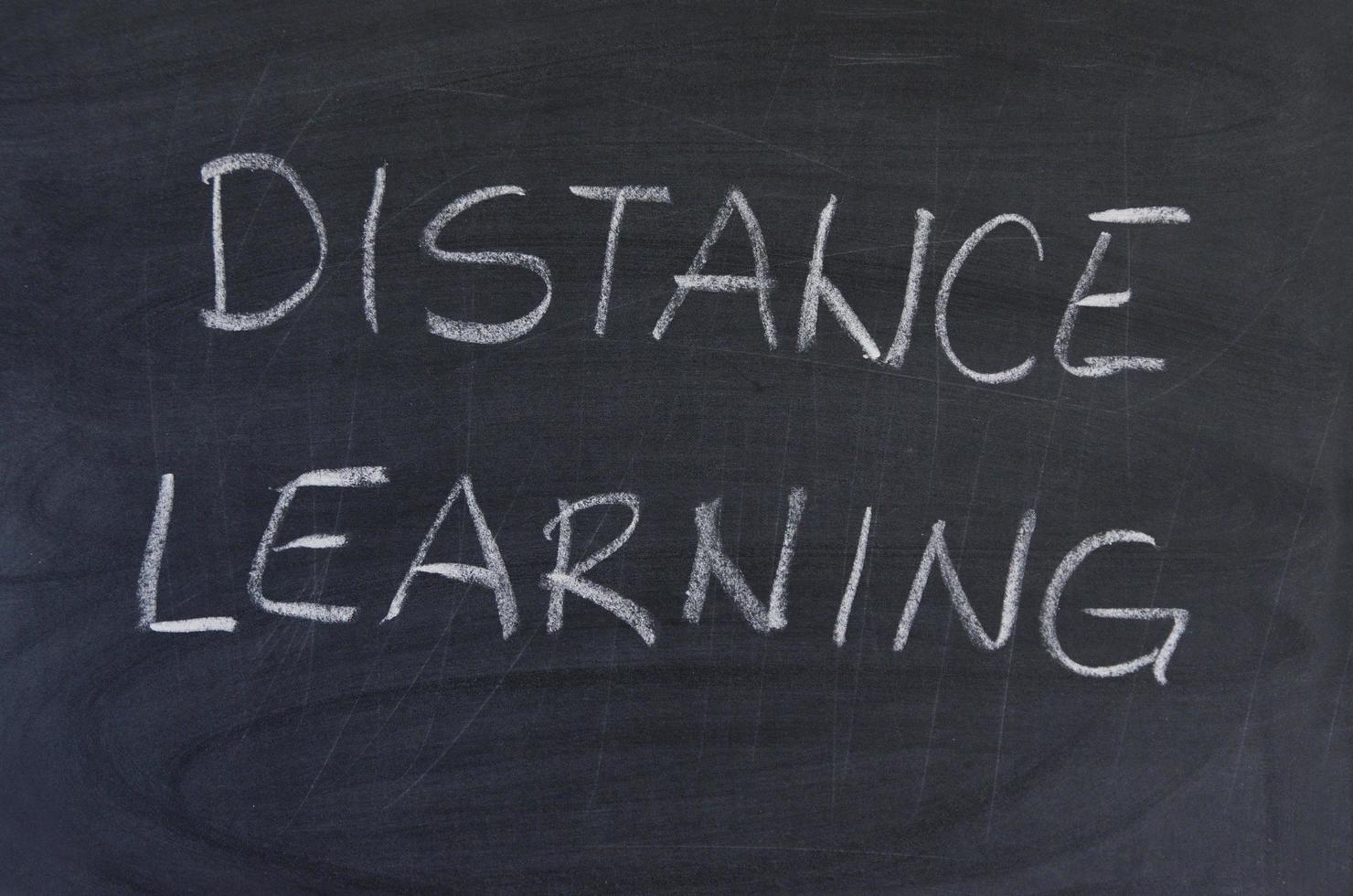 Hand-drawn title Distance Learning on black chalkboard. photo