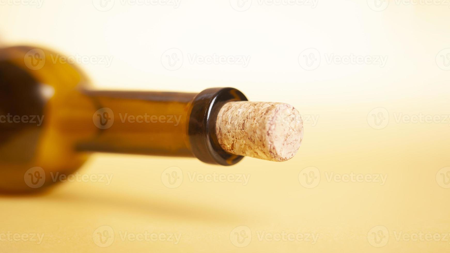 Empty wine bottle on a yellow background photo