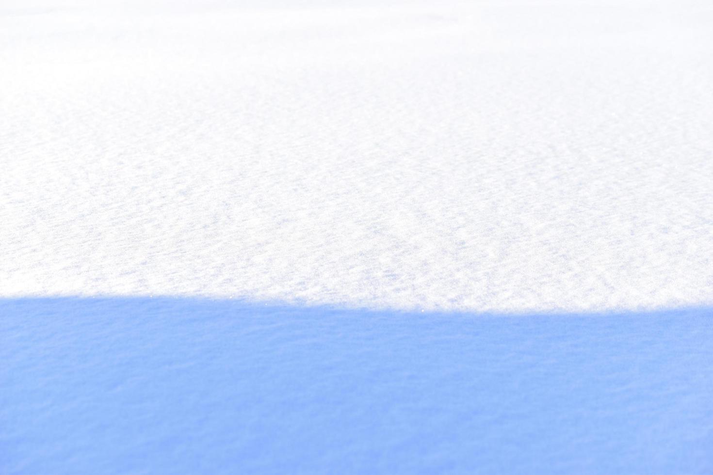 Snowy surface in winter with shadows in the evening photo