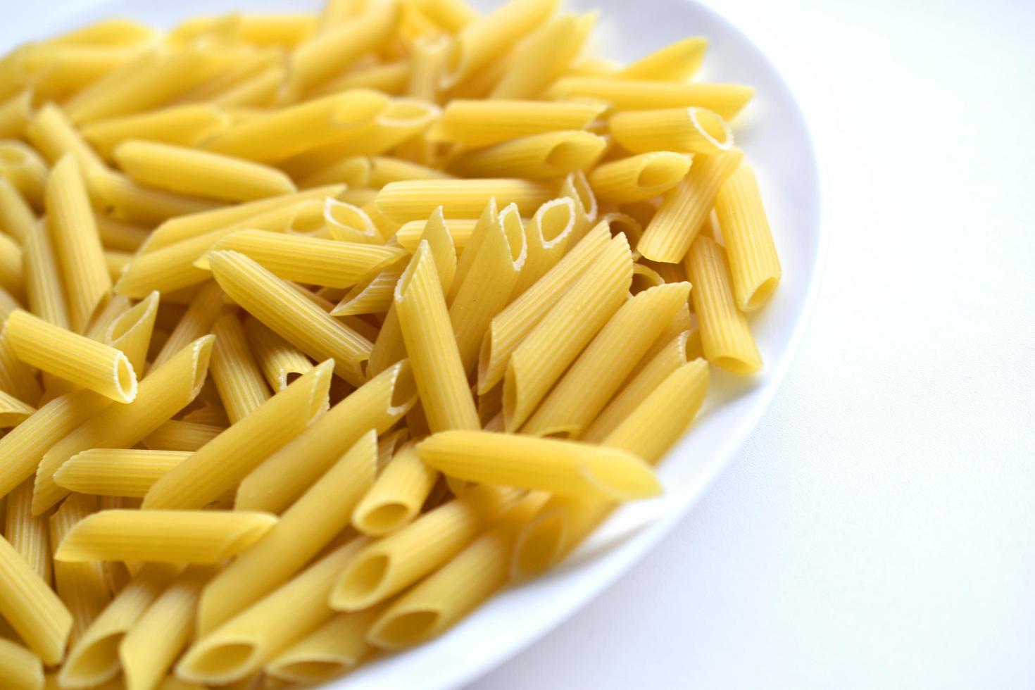 Yellow delicious pasta close-up on a white plate photo