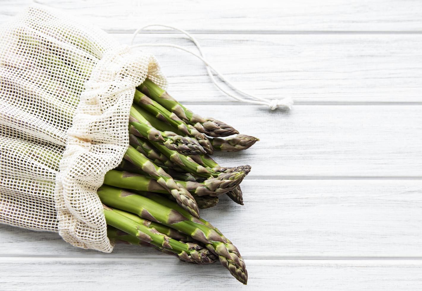 Asparagus stems in an eco mesh bag photo