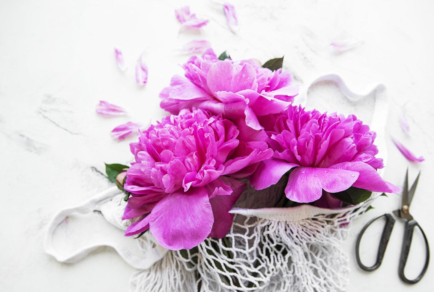 Mesh bag with peony flowers photo