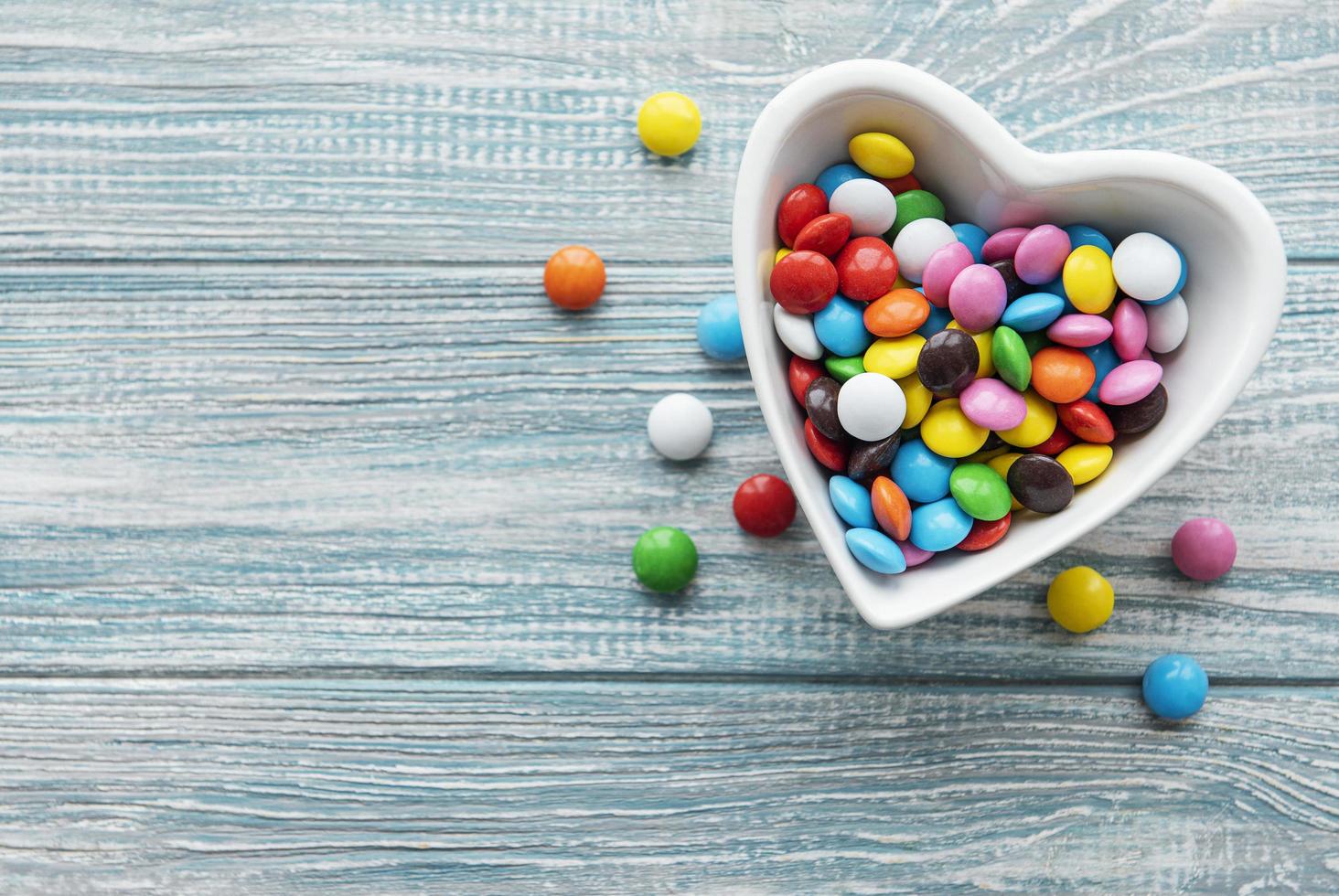 Bowl with multi-colored dragee candies photo