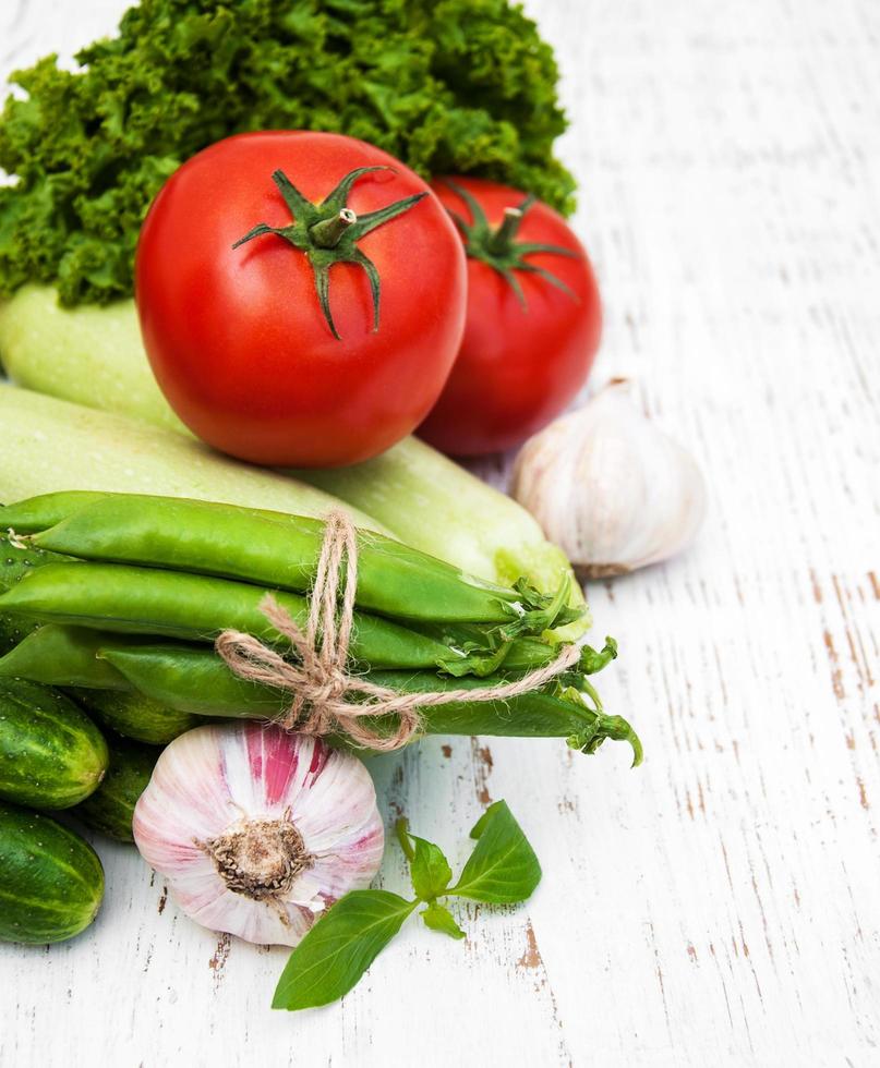 Various vegetables on an old wooden background photo