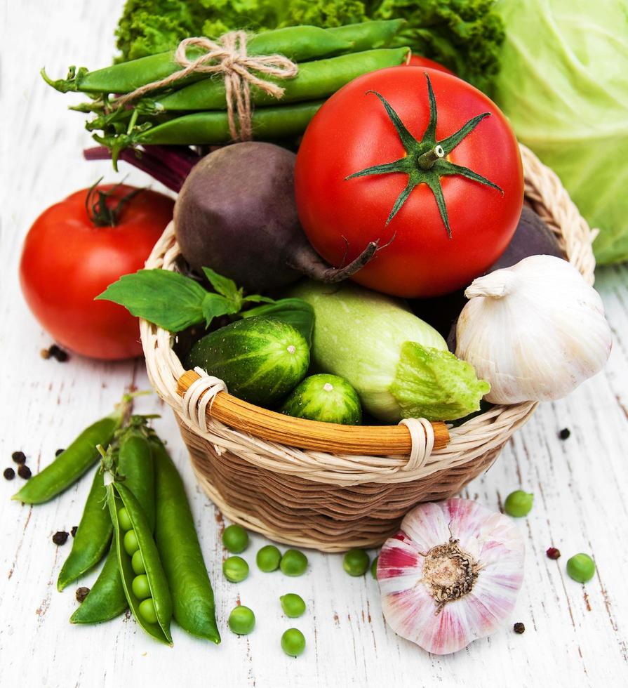 Various vegetables on an old wooden background photo