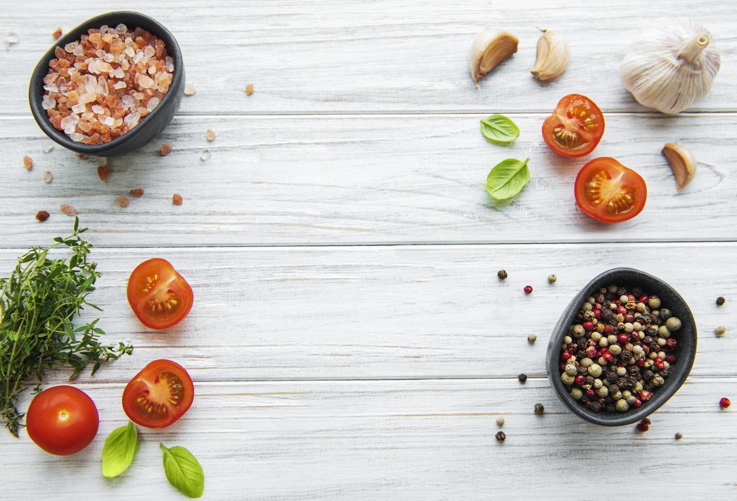 Tomato, basil and pepper with garlic on white wooden background photo