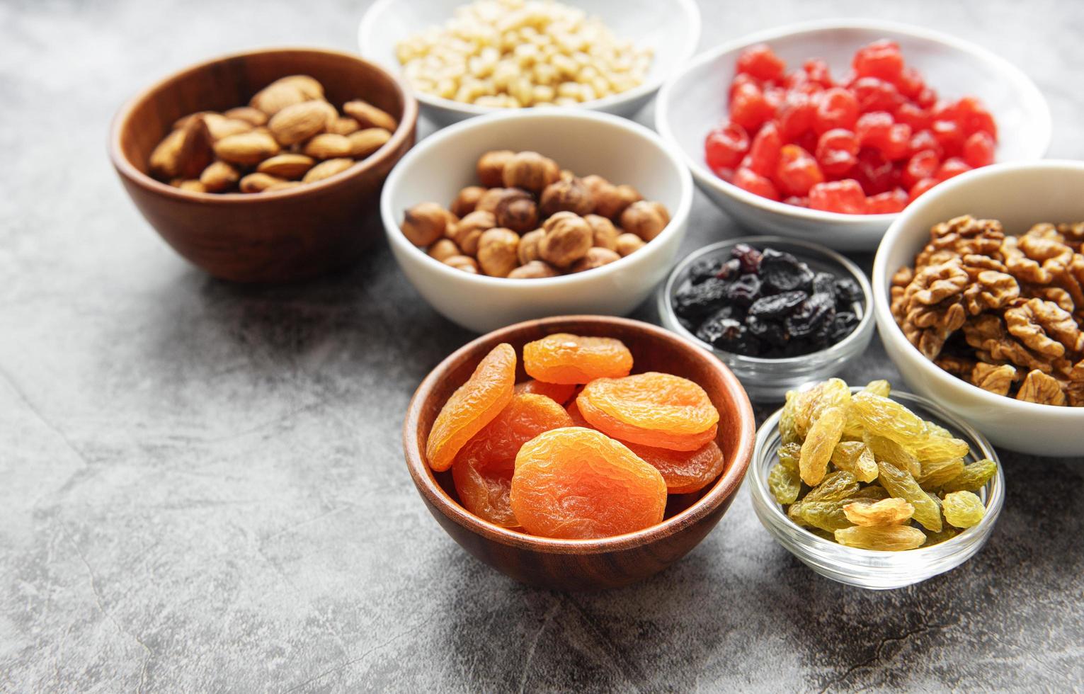 Bowls with various dried fruits and nuts photo