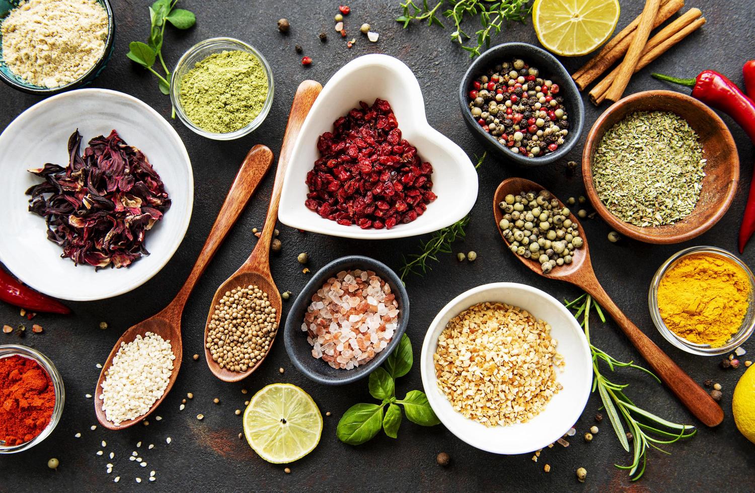 Various spices in a bowl on black concrete background. Top view copy space. photo