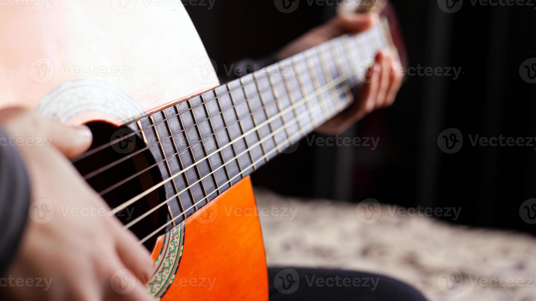 Playing the acoustic guitar, live music and creativity photo