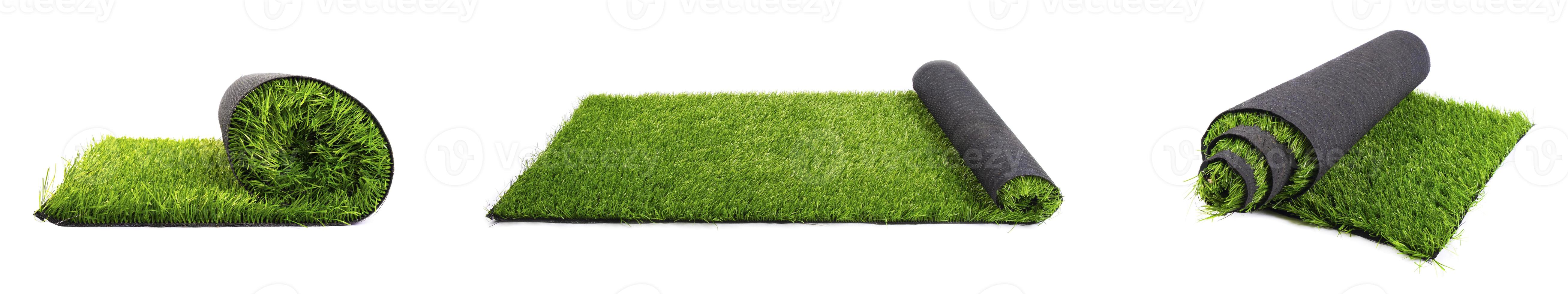 Rolls of artificial lawn panorama on a white background photo