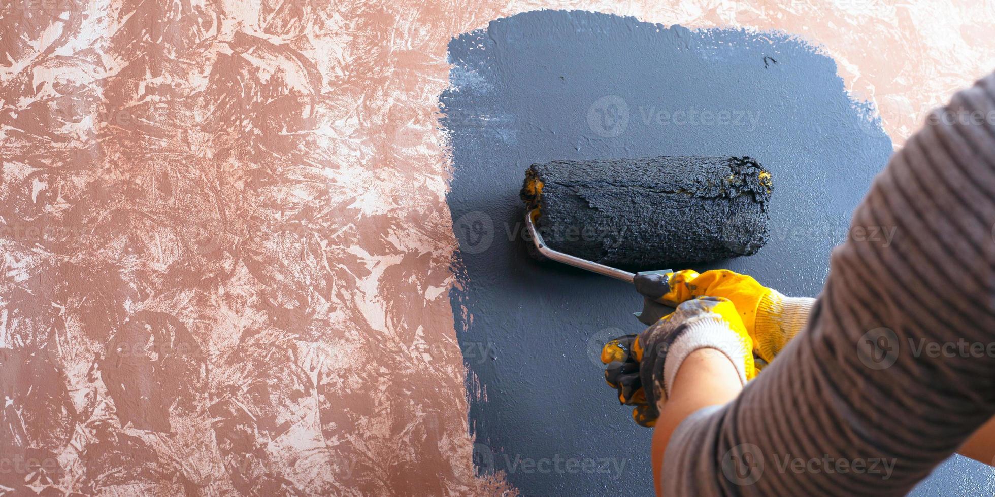 Home repair concept, girl paints a wall photo