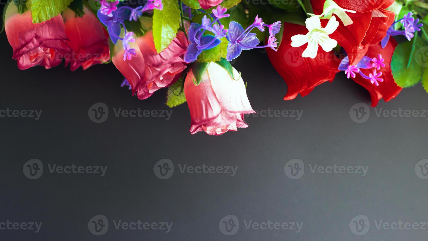 Memorial mockup with artificial flowers on a dark background photo