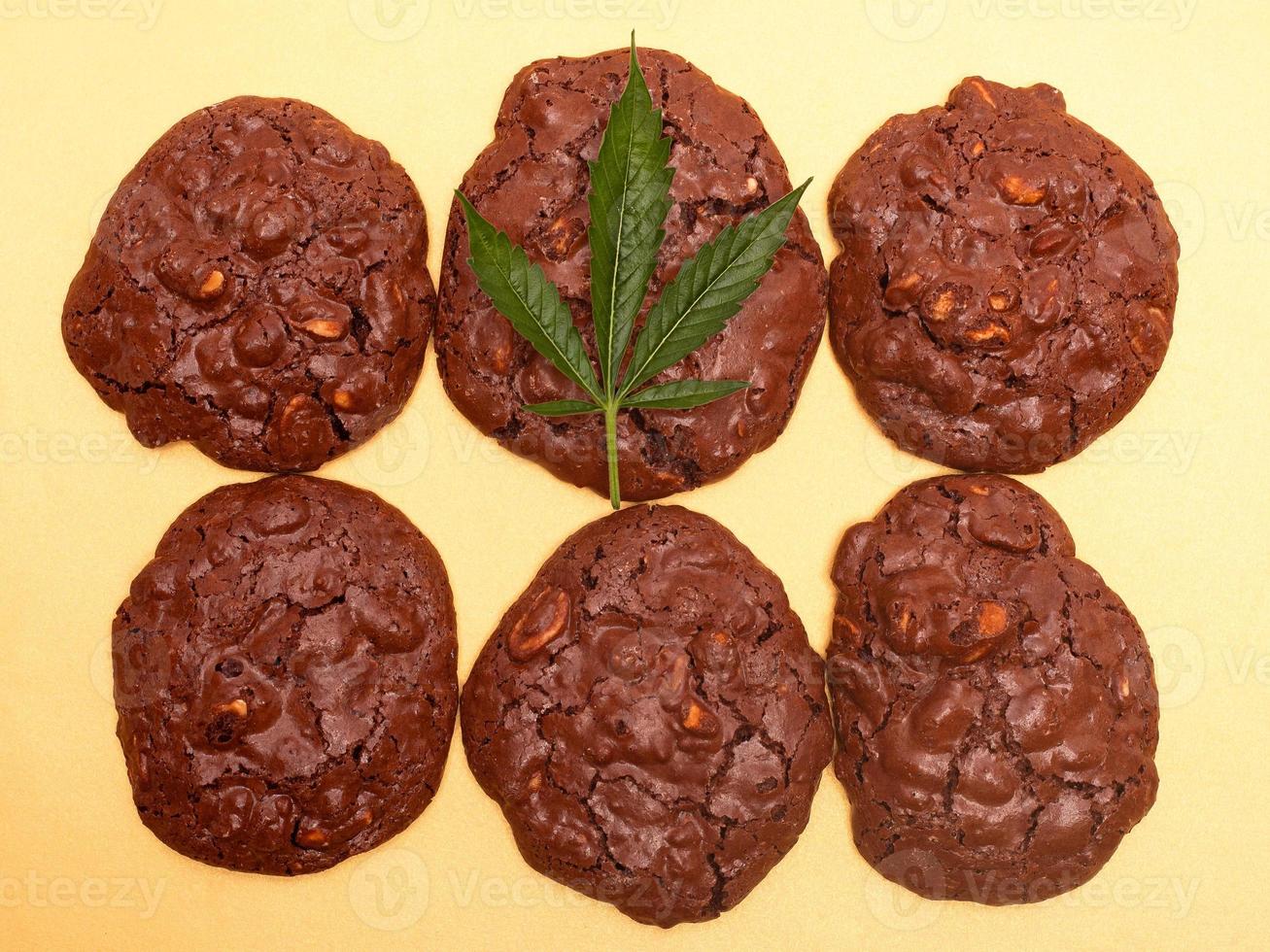 Cannabis cookies and green leaf on a yellow background photo