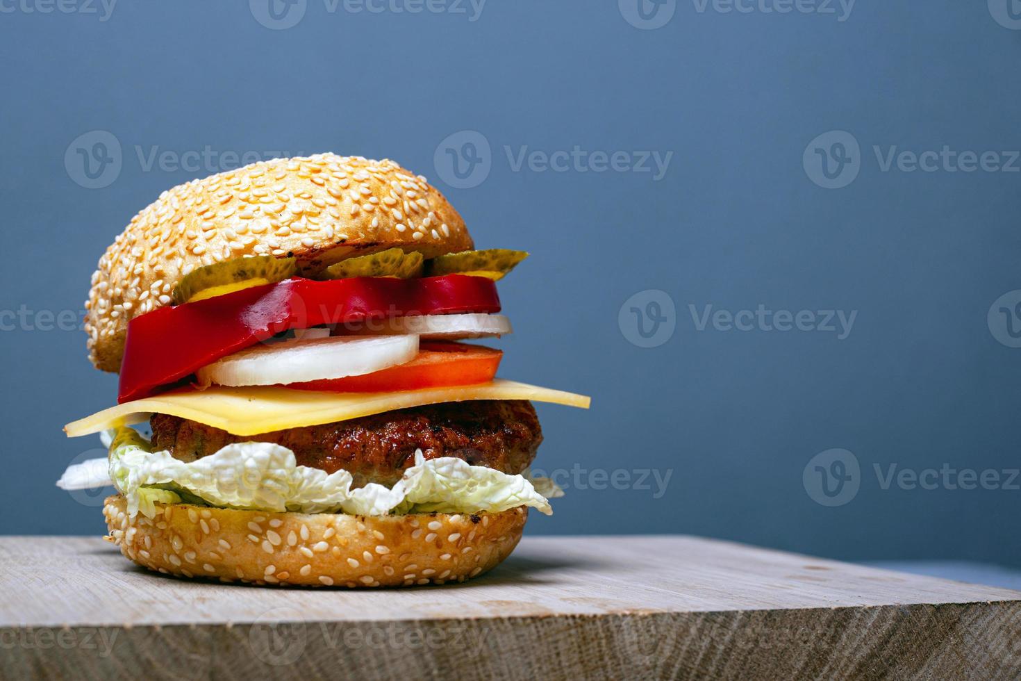 Big juicy burger with copy space on gray background photo