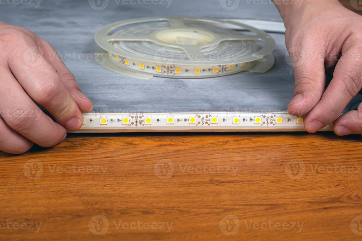 Master installs the LED strip on surface photo