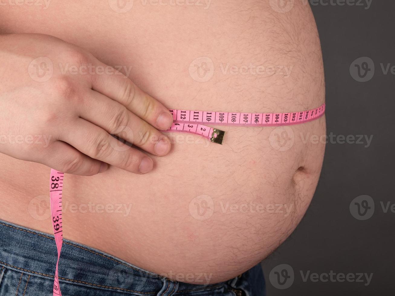 Big belly and centimeter, obese man photo