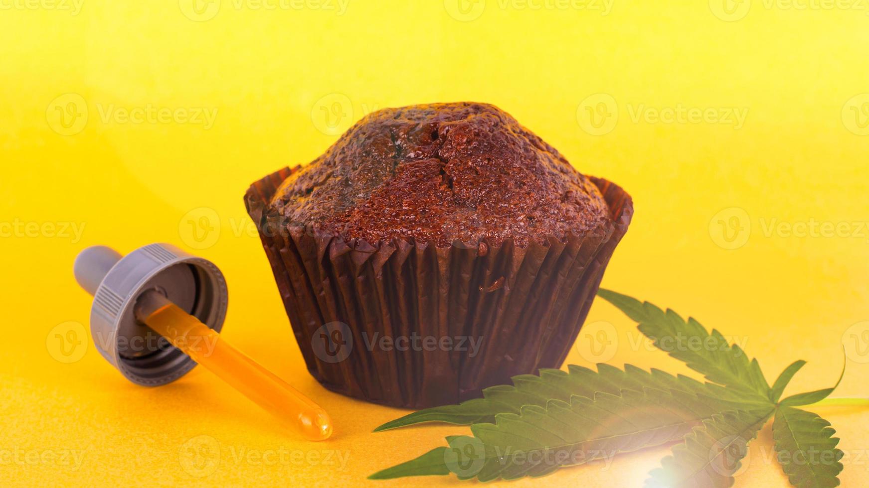 Chocolate cake with THC extract on a yellow background photo