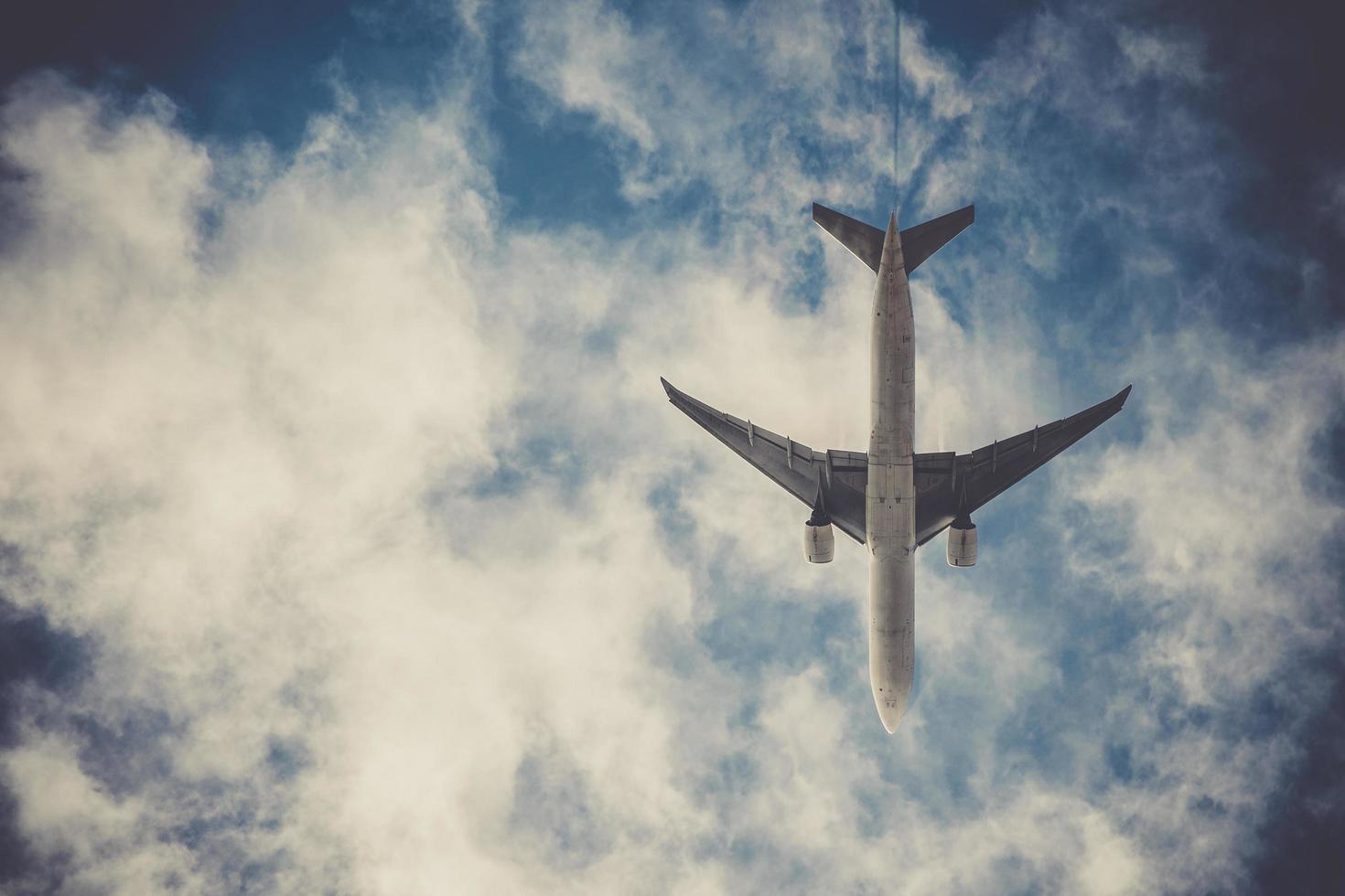 Airplane on blue sky with clouds photo