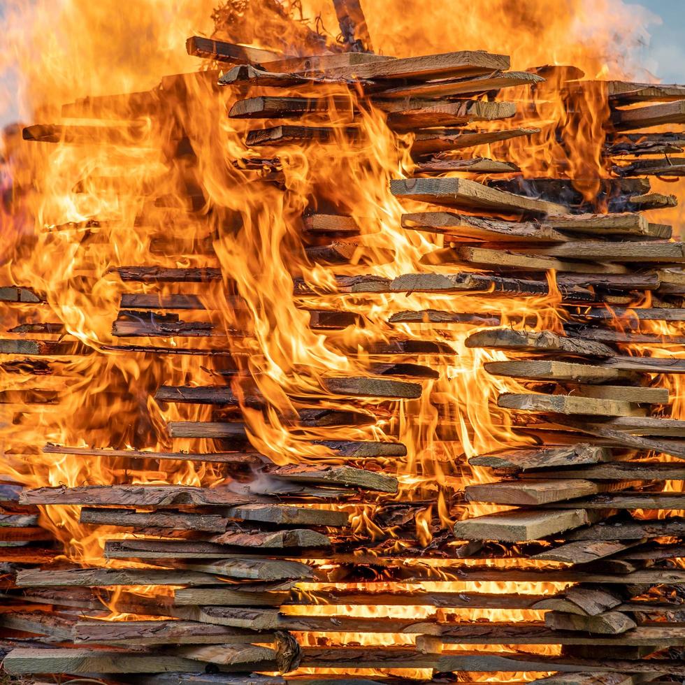 Wooden boards burning with large, orange flames photo