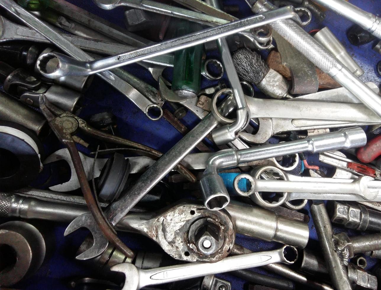 Dirty set of messy hand tools in the garage on a vintage background photo