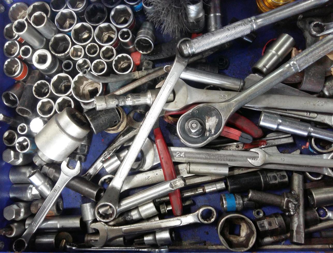 Dirty set of messy hand tools in the garage on a vintage background photo