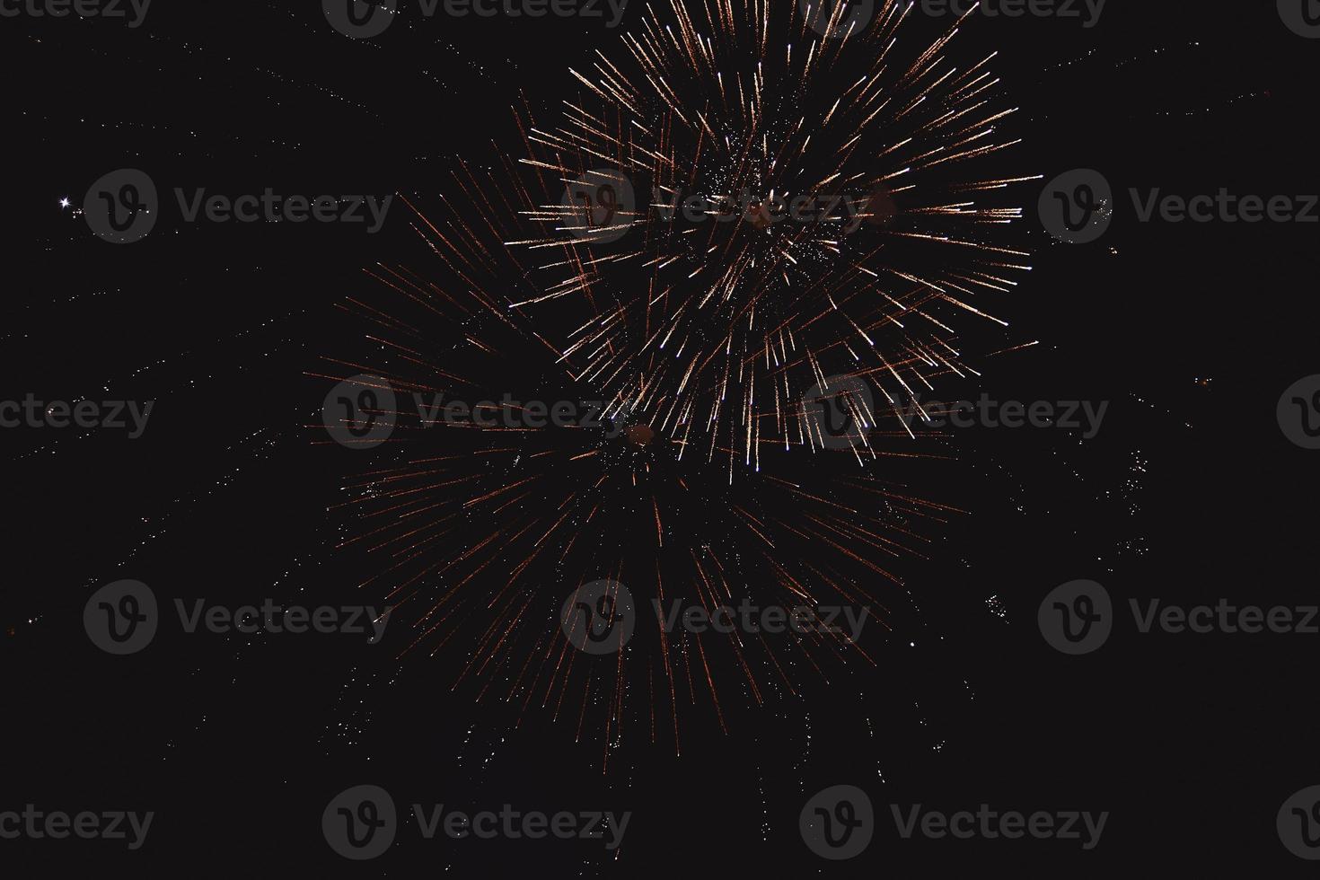 Festive multi-colored pyrotechnics fireworks salute on the dark night sky photo