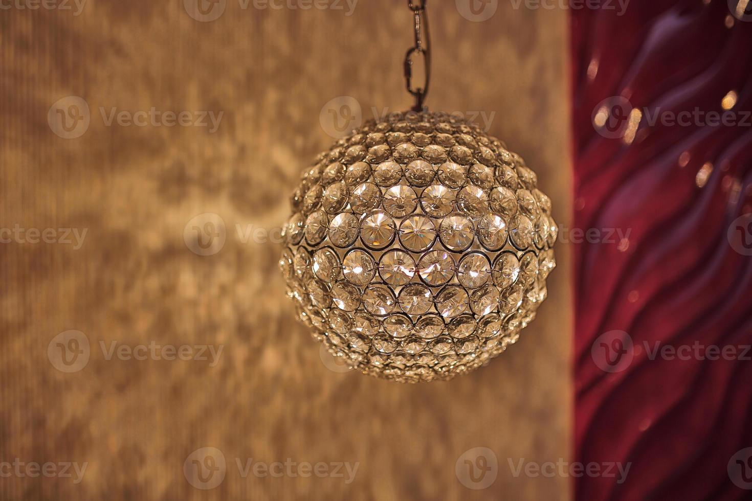 Pendant light lamp illuminated, elegant chandelier illuminated. Round lamp in the interior photo