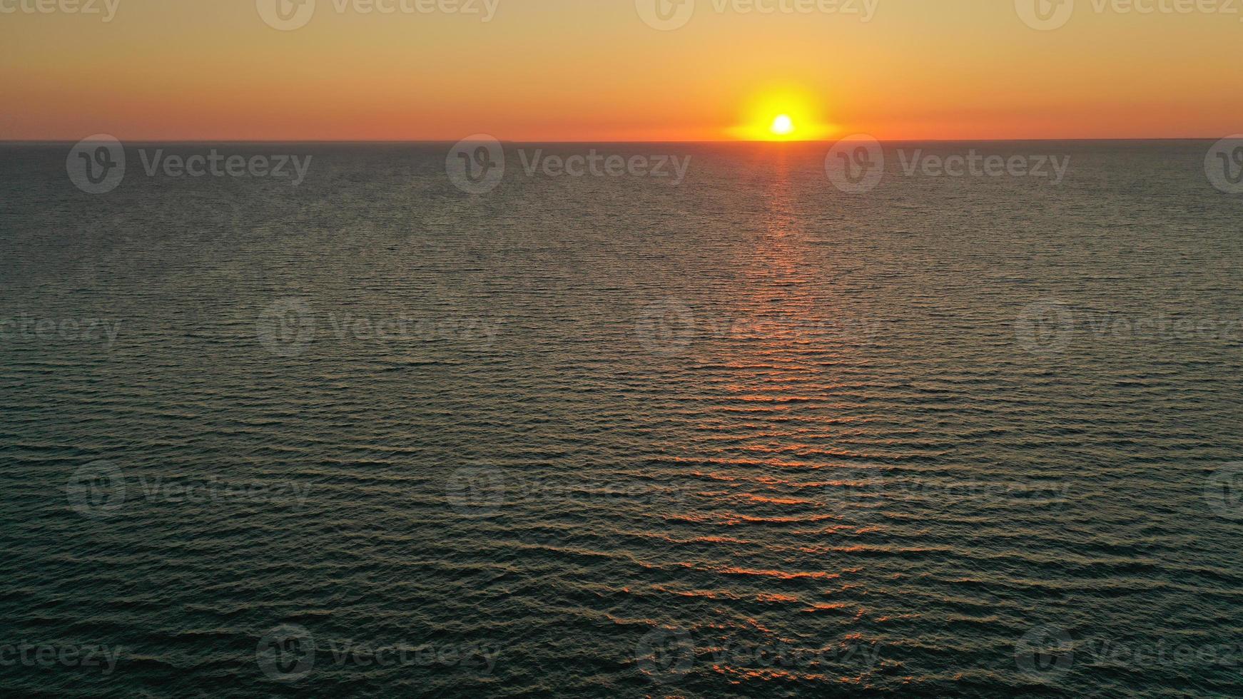 Beautiful sunrise over the horizon. Aerial photography. Sunrise in the ocean. photo