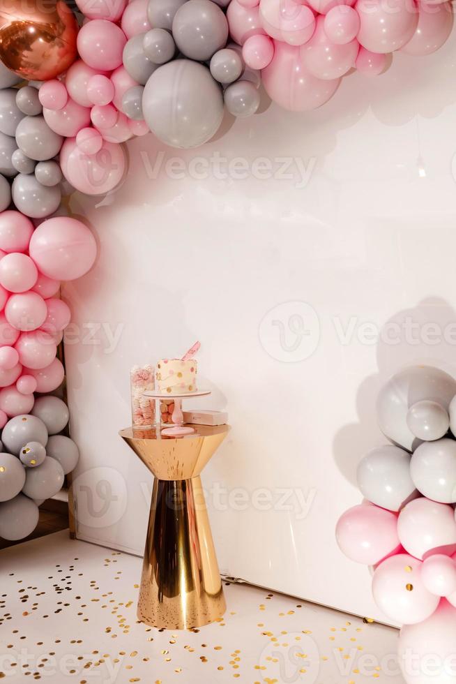 Delicious wedding reception. Birthday cake on a background balloon party decor. Copy space. Celebration concept. Trendy cake. Candy bar. Table with sweets, dessert. photo