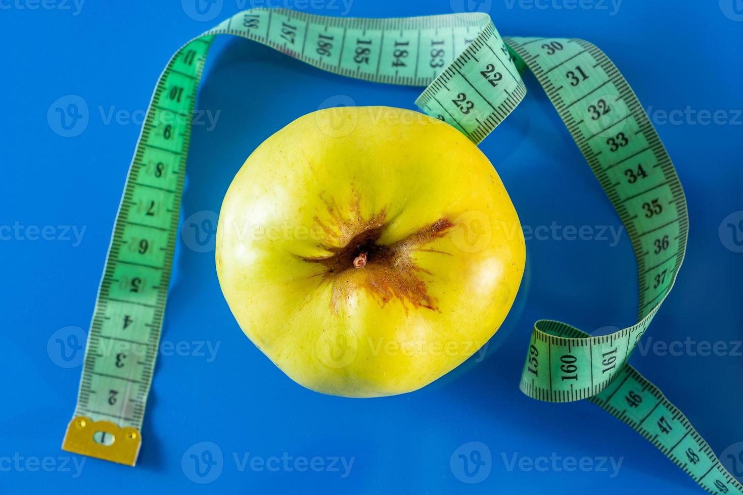 Fruits and measuring tapes on a blue background photo