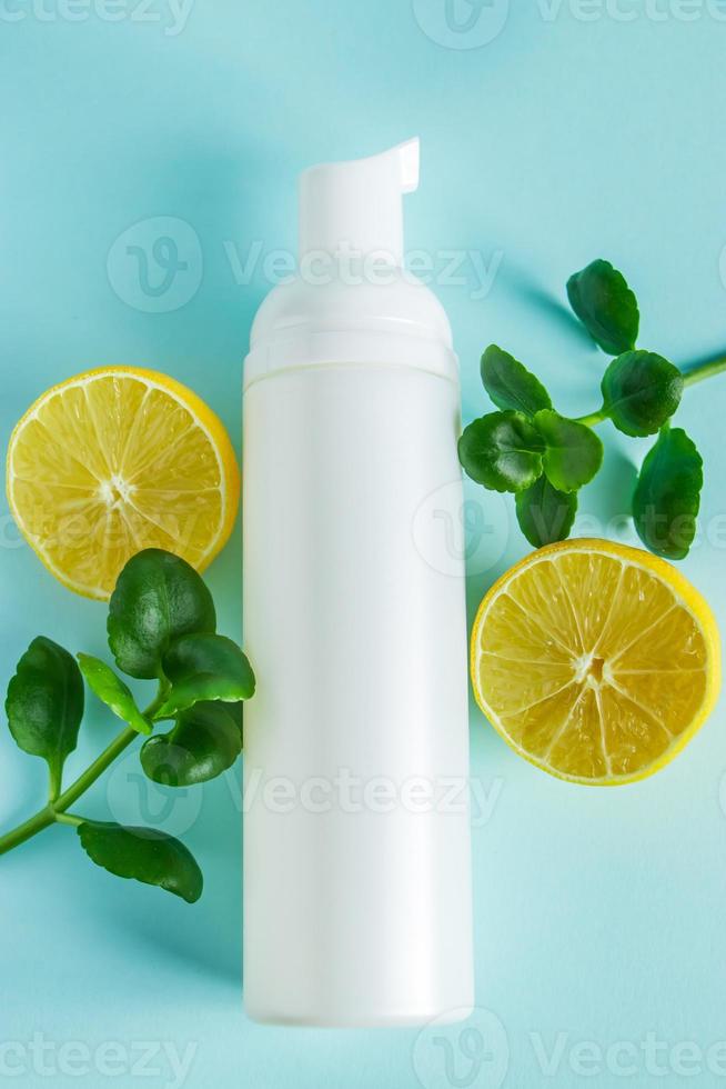 Organic cosmetics with lemon oil on a blue background photo
