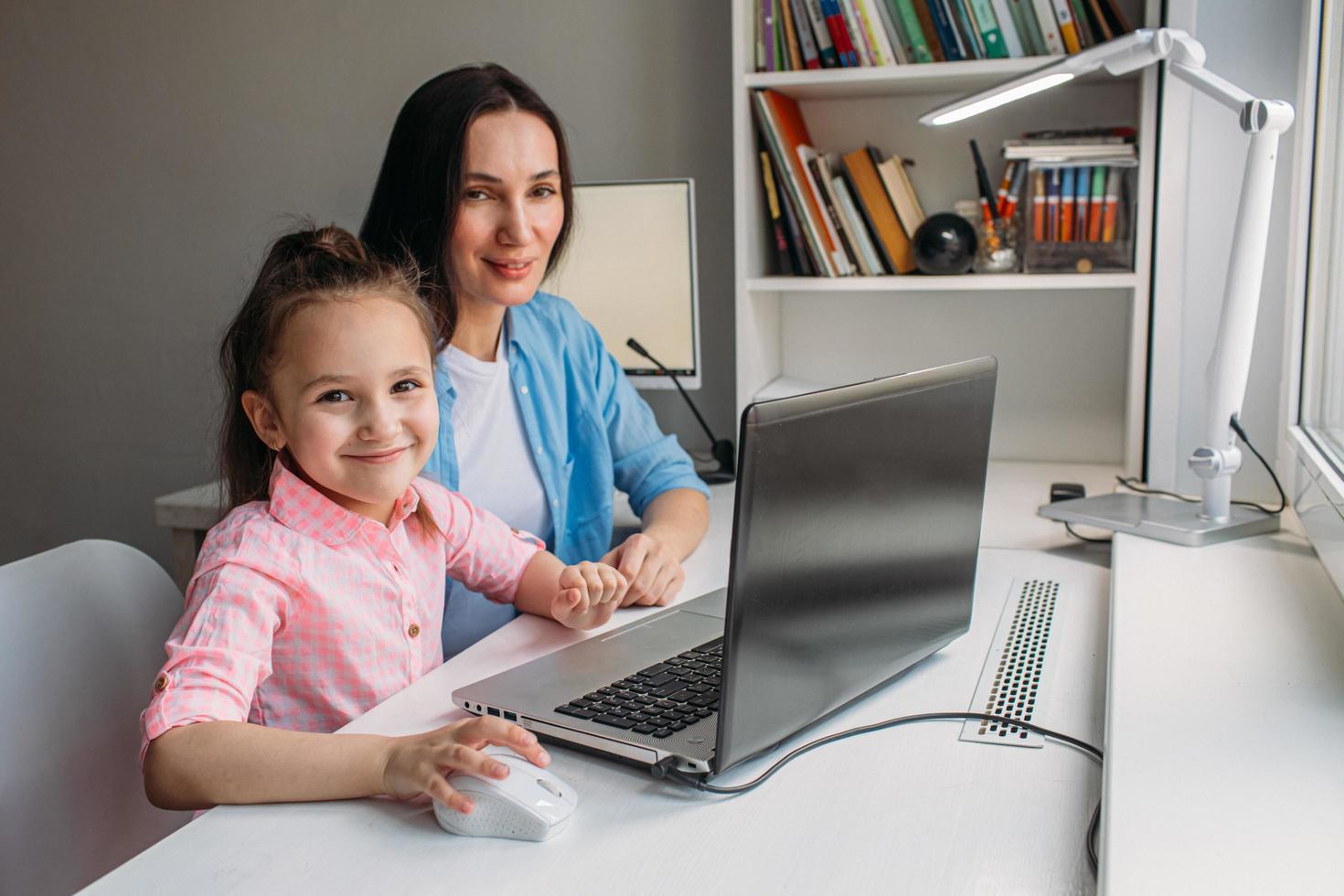 Mom and daughter posing with laptop photo