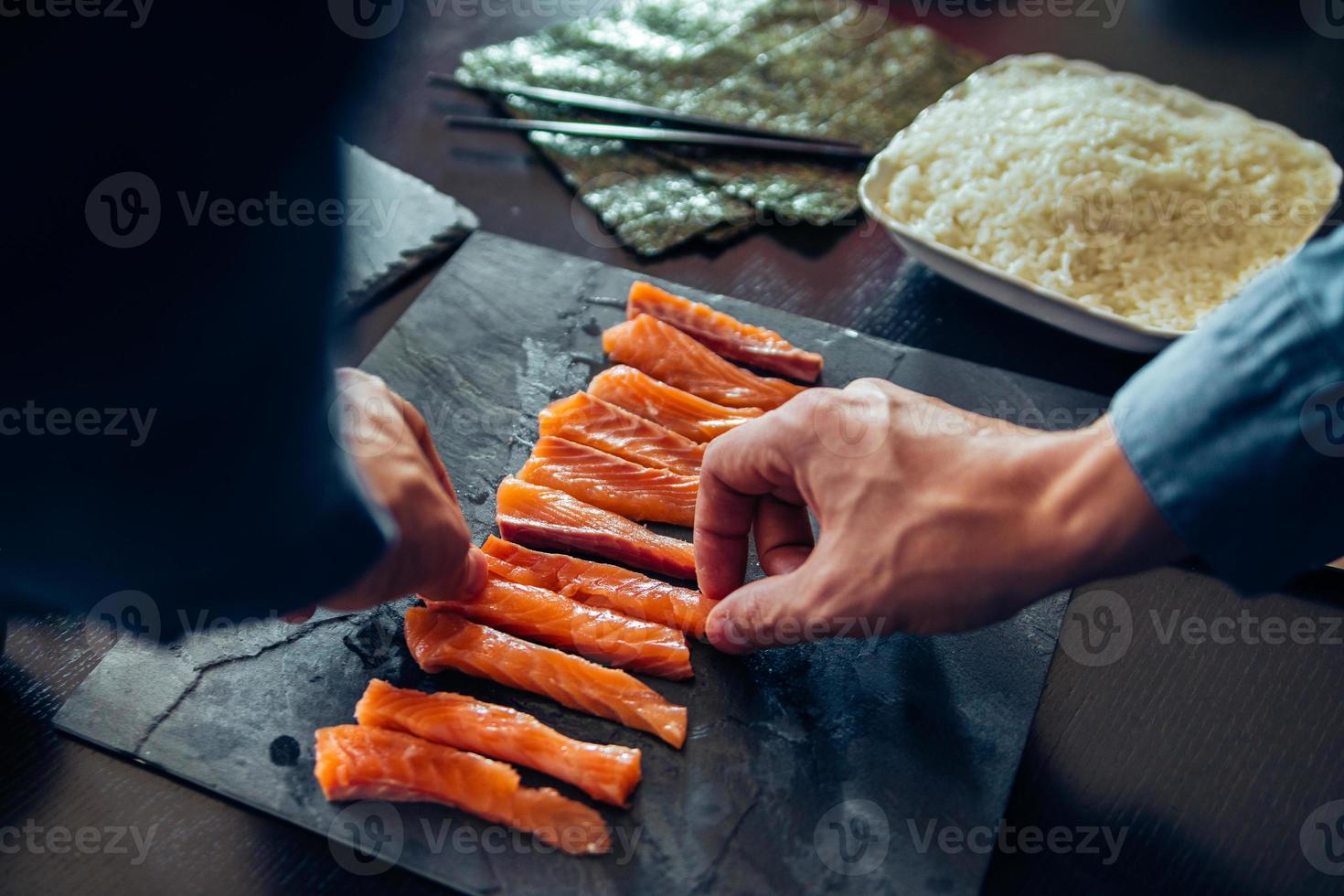 persona plateando salmón en rodajas foto