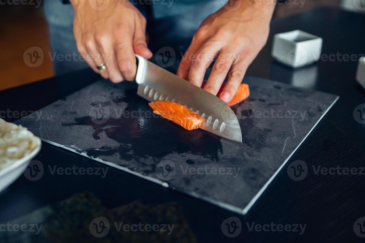 Chef cutting salmon photo