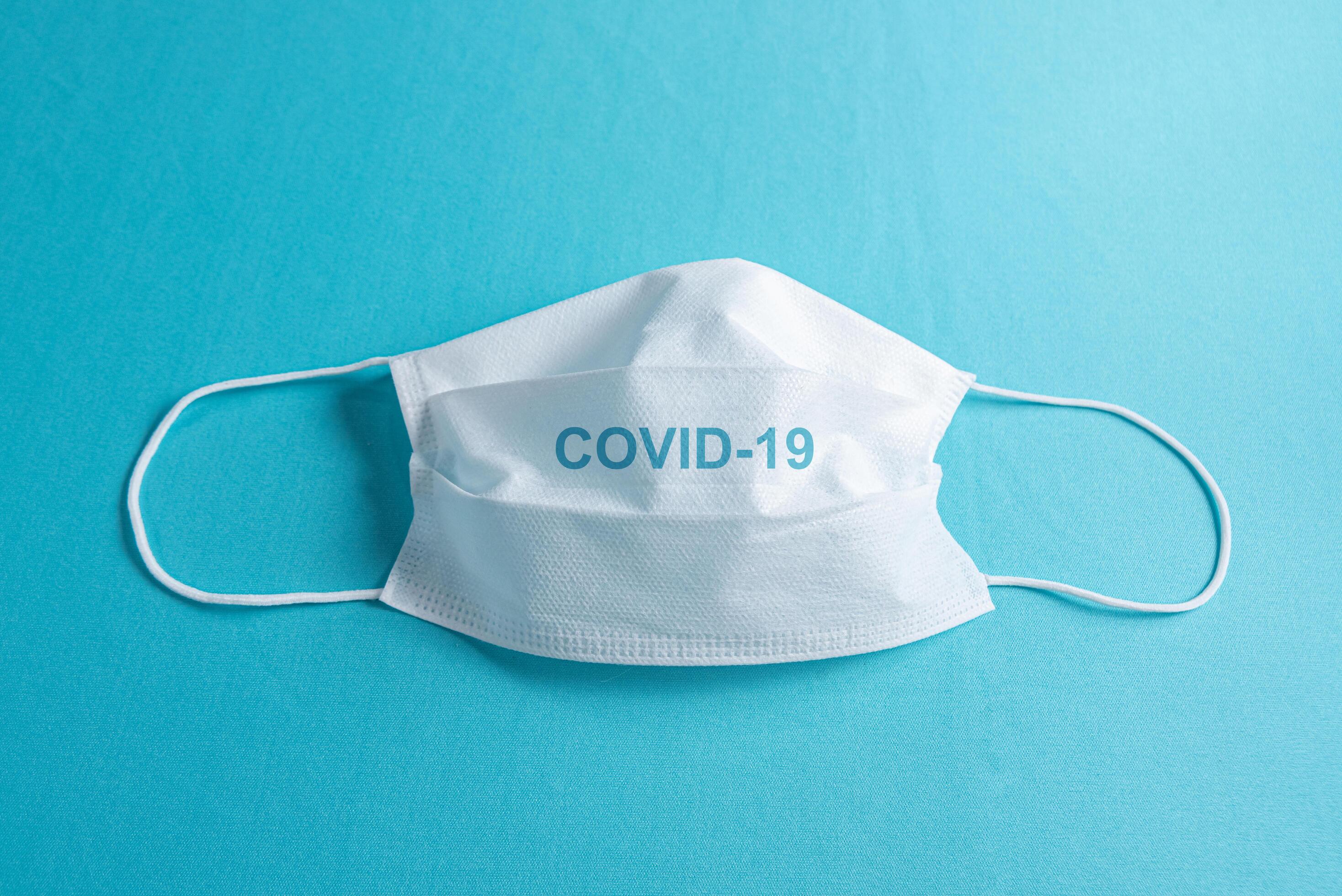 Surgical mask over minimalist blue background 2257713 Stock Photo at