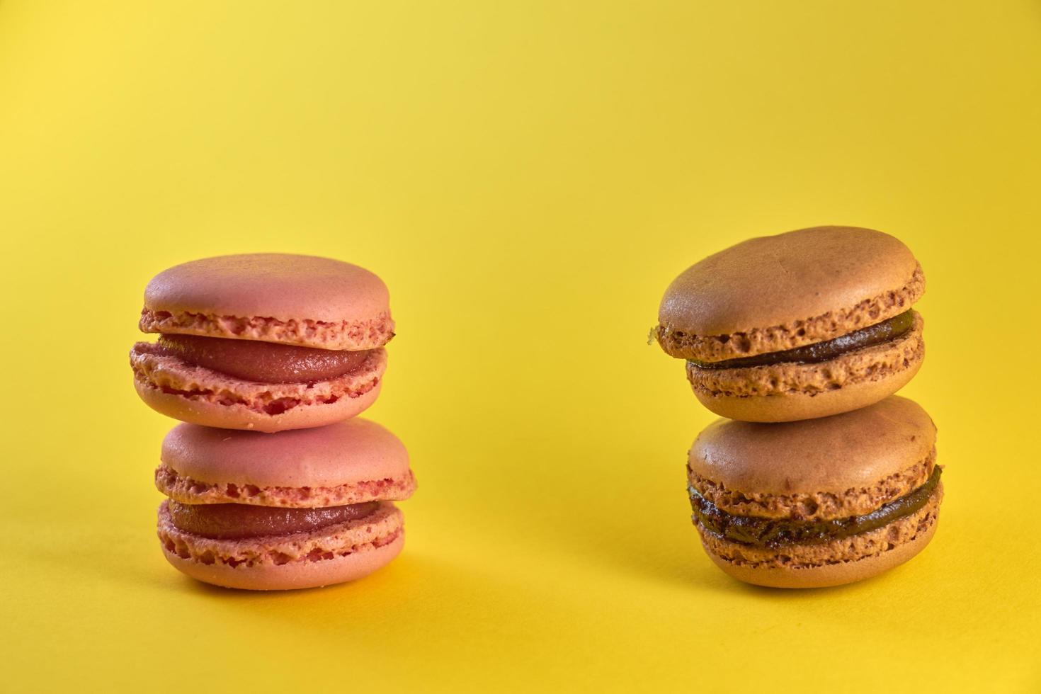Cake macaron close up on a yellow background, flavor almond cookies pastel colors, and space for text. photo