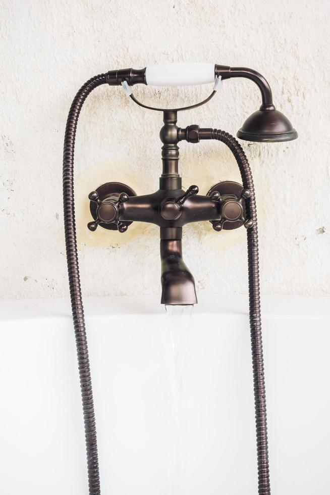 Old vintage faucet on bathtub photo