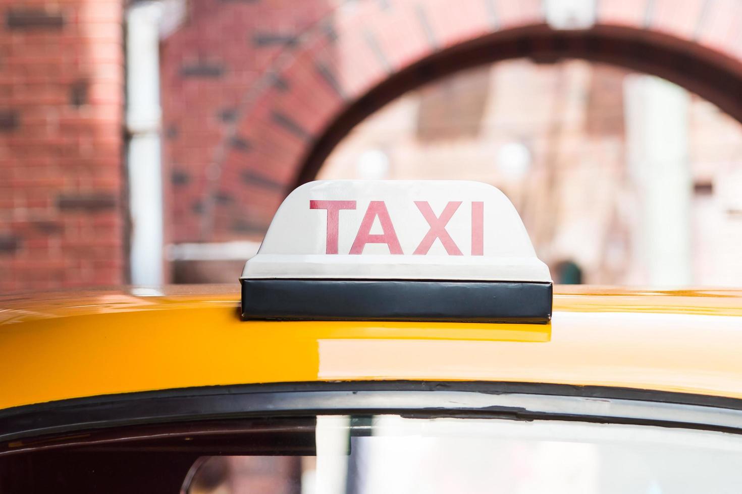 Taxi sign on on the roof of a car photo