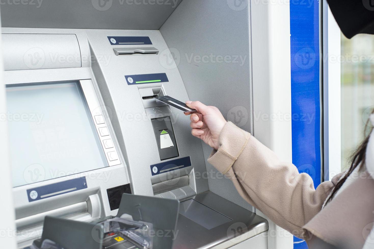 Young woman using the ATM photo