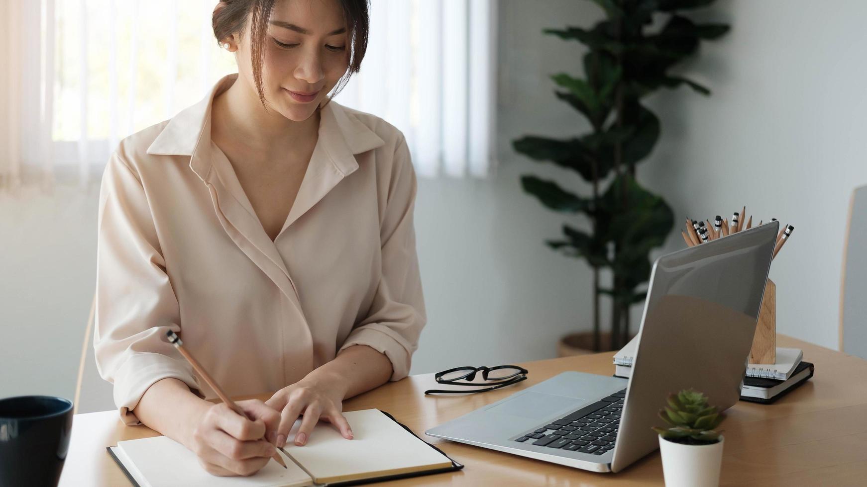 Woman writing in a notebook photo