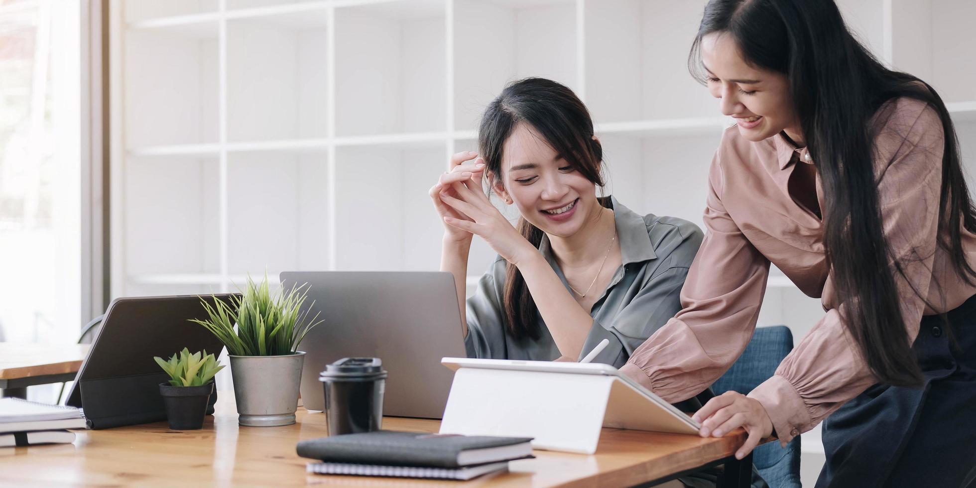 Two coworkers using a tablet photo