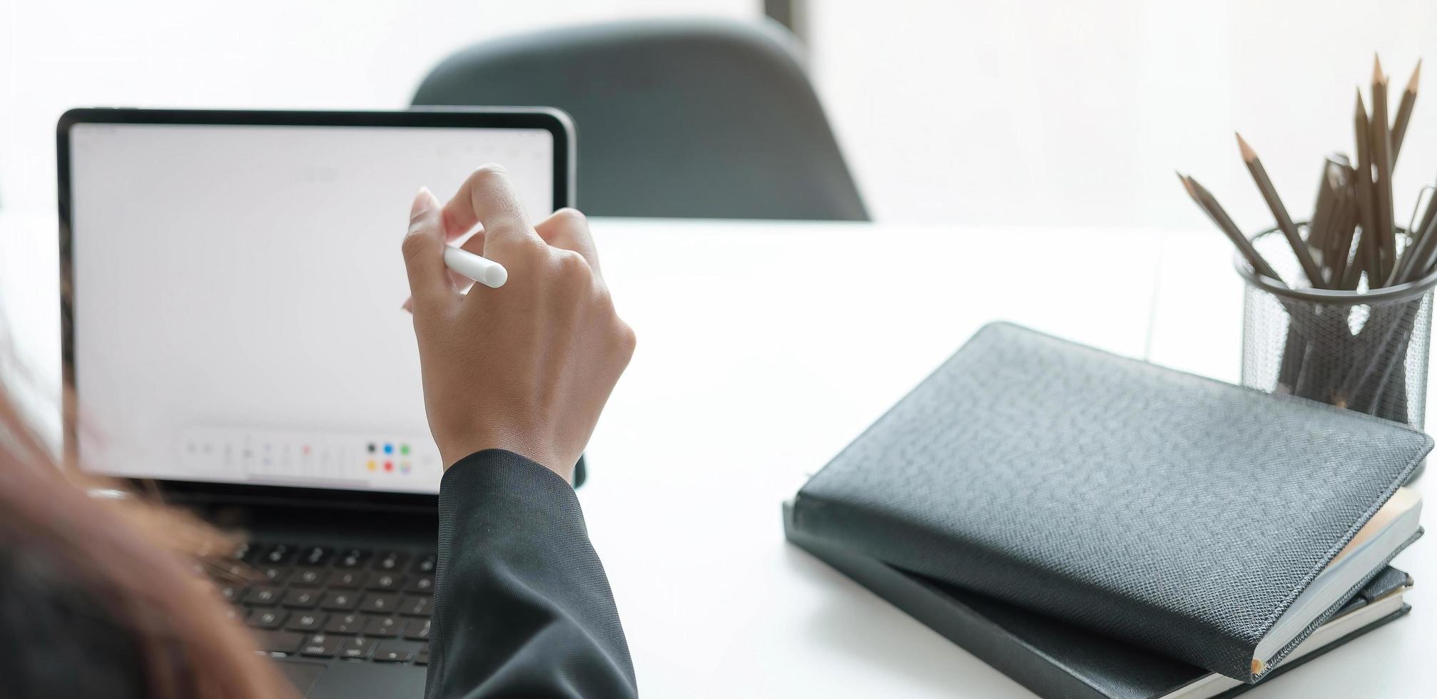 Person taking notes on a tablet photo